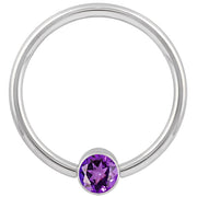 14k white gold fixed bead ring with purple CZ bezel, smaller gauge shown front view