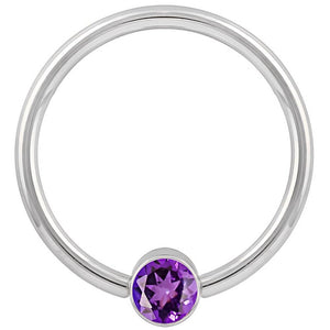 14k white gold fixed bead ring with purple CZ bezel, smaller gauge shown front view