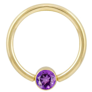 14k yellow gold fixed bead ring with purple CZ round bezel setting, front view