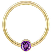 14k yellow gold purple CZ fixed bead ring, smaller gauge highlighting bezel-set stone