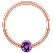14k rose gold fixed bead ring with purple CZ round bezel setting, smaller gauge front view