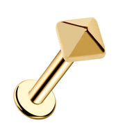 14k yellow gold pyramid flat-back labret stud, angled view showing polished faceted charm and disc backing