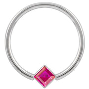 14k white gold fixed bead ring with red princess-cut CZ in corner-mount bezel, front view