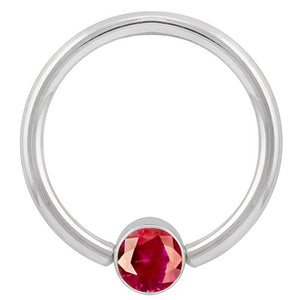 14k white gold fixed bead ring with round red cubic zirconia bezel, angled front view