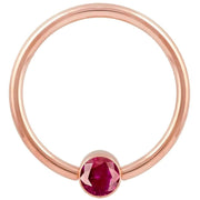 14k rose gold red cubic zirconia bezel fixed bead ring, straight-on front view showing full hoop