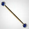 14k yellow gold industrial barbell with dual blue round CZ gems in prong settings, front view