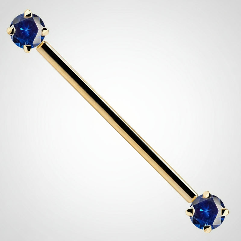 14k yellow gold industrial barbell with dual blue round CZ gems in prong settings, front view