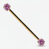 14k yellow gold industrial barbell with pink CZ ends, prong-set round-cut gems, front view