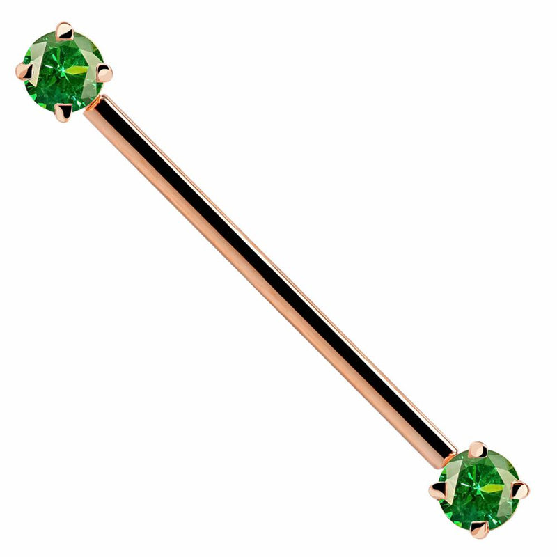 14k rose gold industrial barbell with green round CZ gems at each end, front view