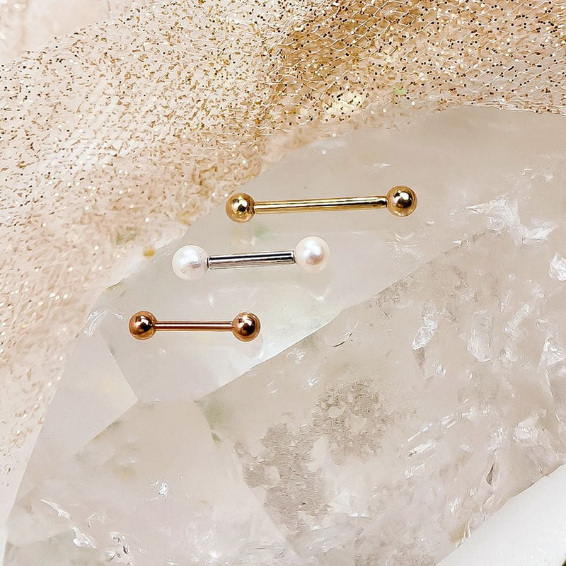 14k yellow gold, white gold, and rose gold straight barbells grouped on crystal rock with pearl-end style shown