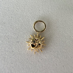 14K yellow gold sun moon charm on textured surface showing actual size and dimensional detail