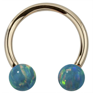 14k yellow gold circular barbell with teal simulated opal balls, front view