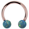 14k rose gold circular barbell with teal simulated opal balls, front view