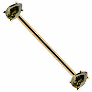 14k yellow gold industrial barbell with two pear-cut light green CZ gems in prong settings, diagonal view