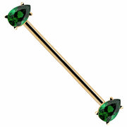 14k yellow gold industrial barbell with dual green pear-cut CZ gems in prong settings, white background