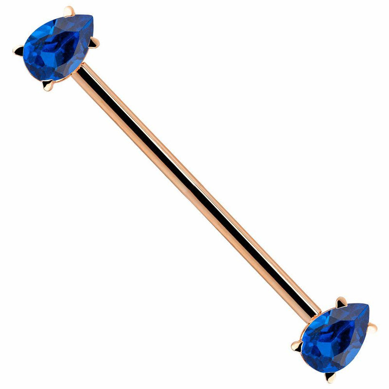 14k rose gold industrial barbell with dual blue teardrop CZ gems in prong settings, diagonal view
