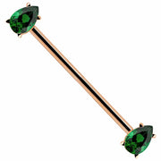 14k rose gold industrial barbell with dual green pear-cut CZ gems in prong settings, white background