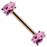 14K rose gold straight barbell with dual pink pear-cut CZ gemstones, angled view showing warm gold tone