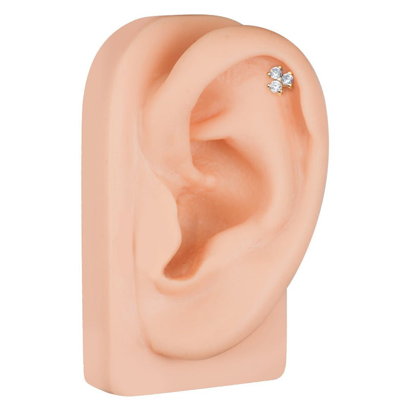 Triple CZ 14k gold cartilage stud shown in upper helix piercing on mannequin ear for placement reference