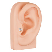 Triple CZ 14k gold cartilage earring shown in tragus or mid-ear piercing on mannequin for size reference