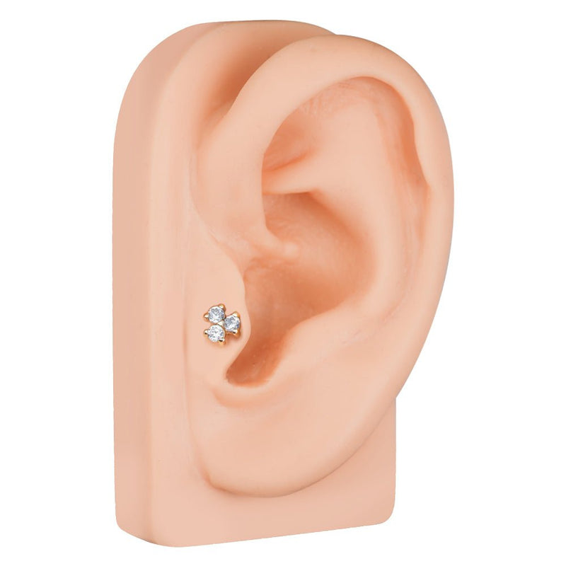 Triple CZ 14k gold cartilage earring shown in tragus or mid-ear piercing on mannequin for size reference