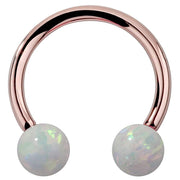 14k rose gold circular barbell with iridescent white opal ball ends, front view